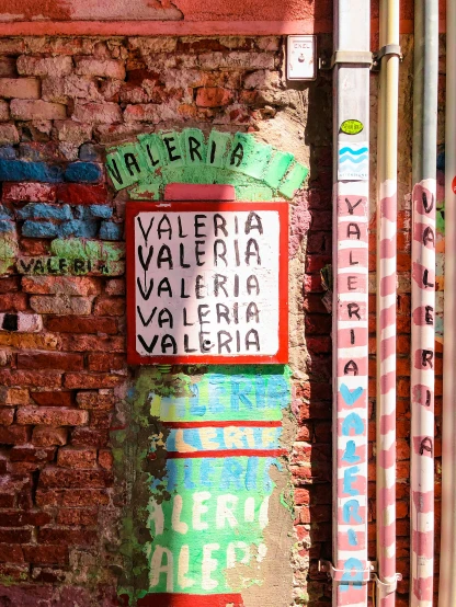 a brick wall with street signs painted on it