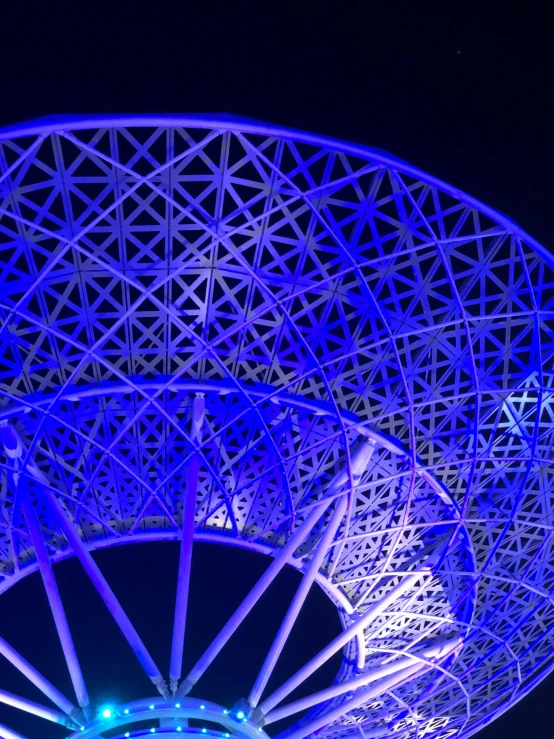 an illuminated steel structure with a star in it