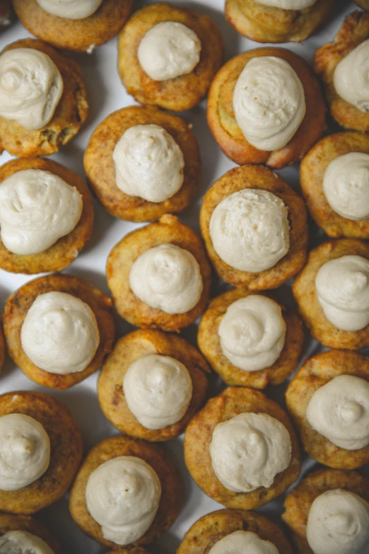 close up of small pastries with cream on top