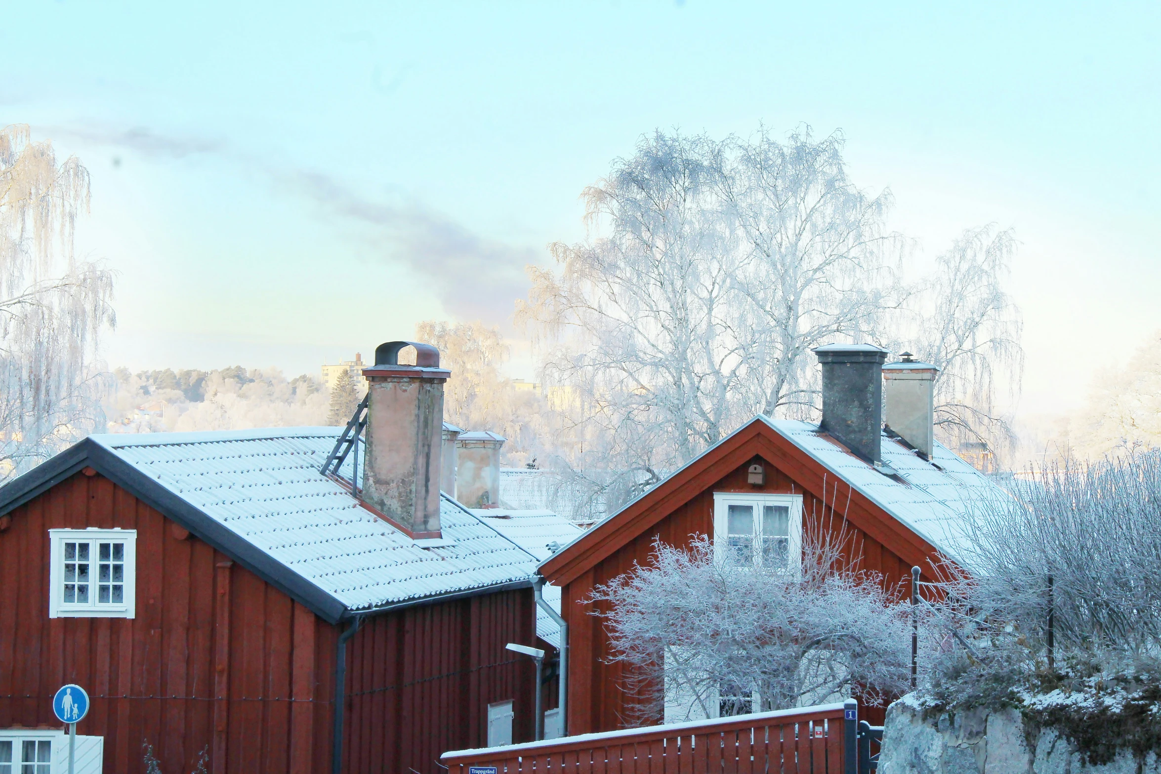 a very small house and snowy trees and shrubs