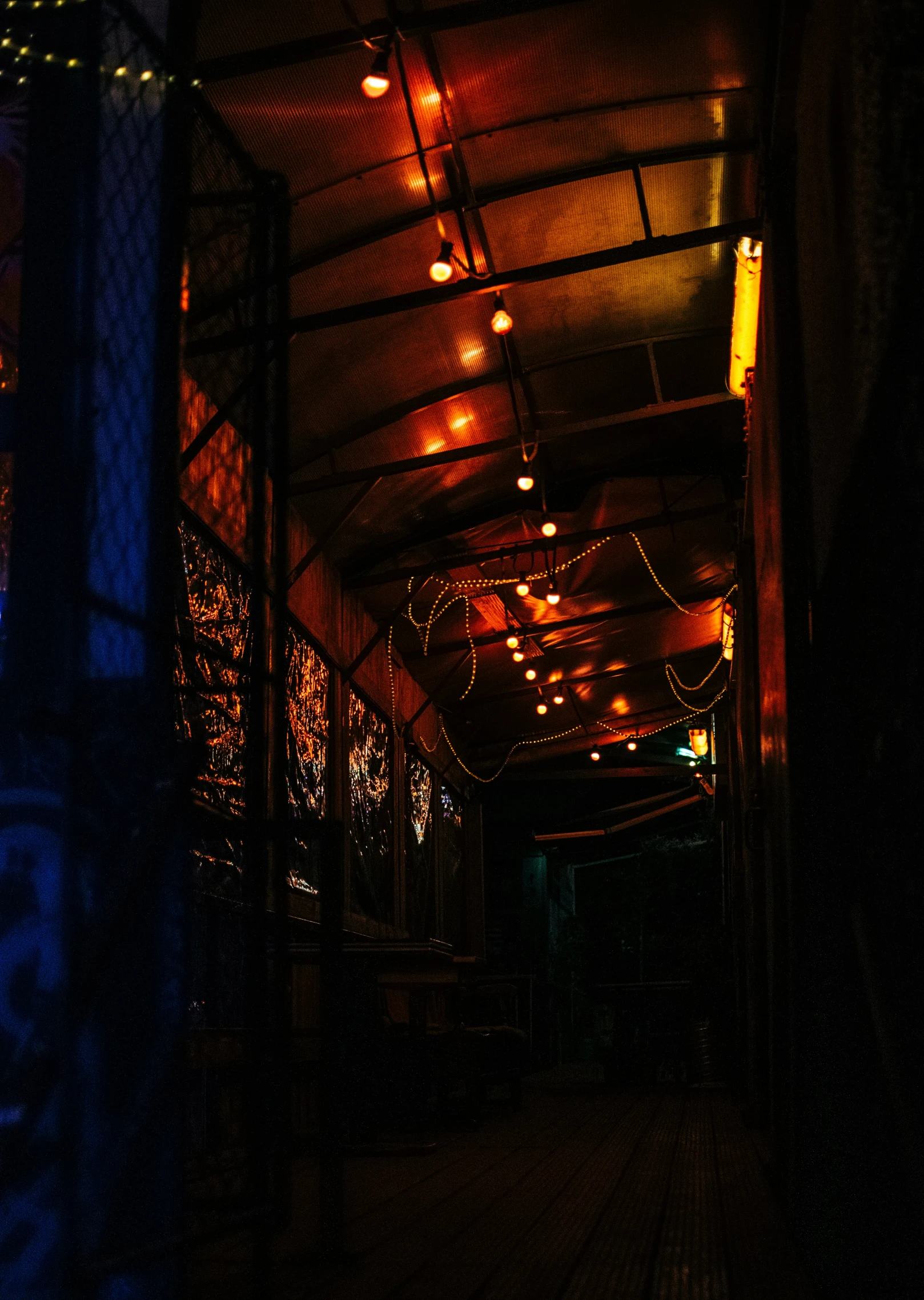 a dimly lit walkway with lights at night