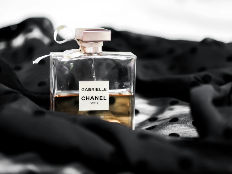 a chanel bottle is on a black blanket