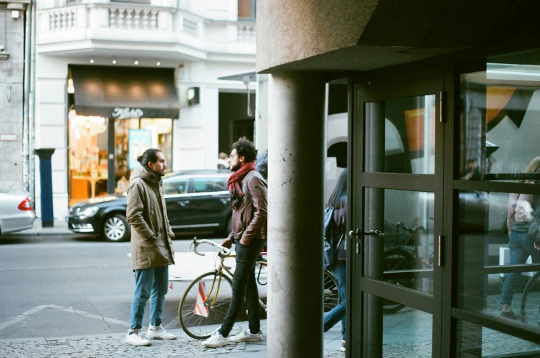 two men walking down the street in the city