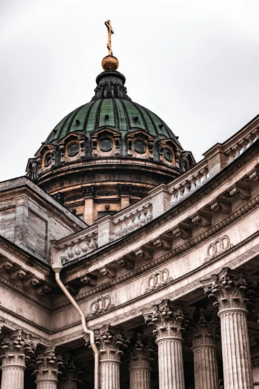 the view of a stone building with columns and a dome