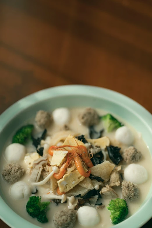 the bowl has mushrooms, broccoli and carrots in it