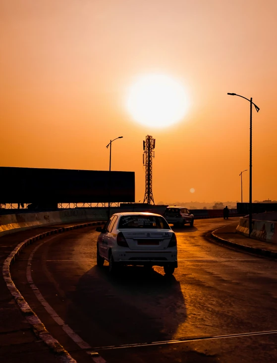 a car is driving on a road during the sun