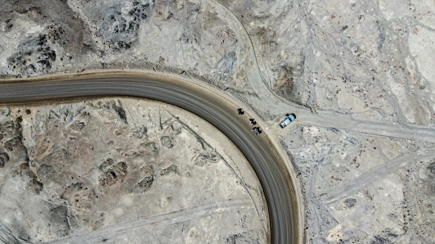 a curve in the road is surrounded by rocky terrain