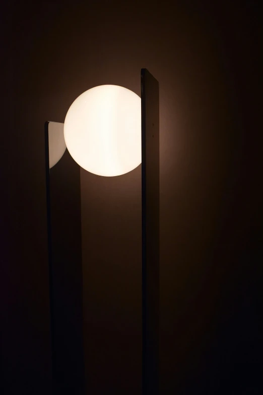 a modern style lamp lit by two thin black poles