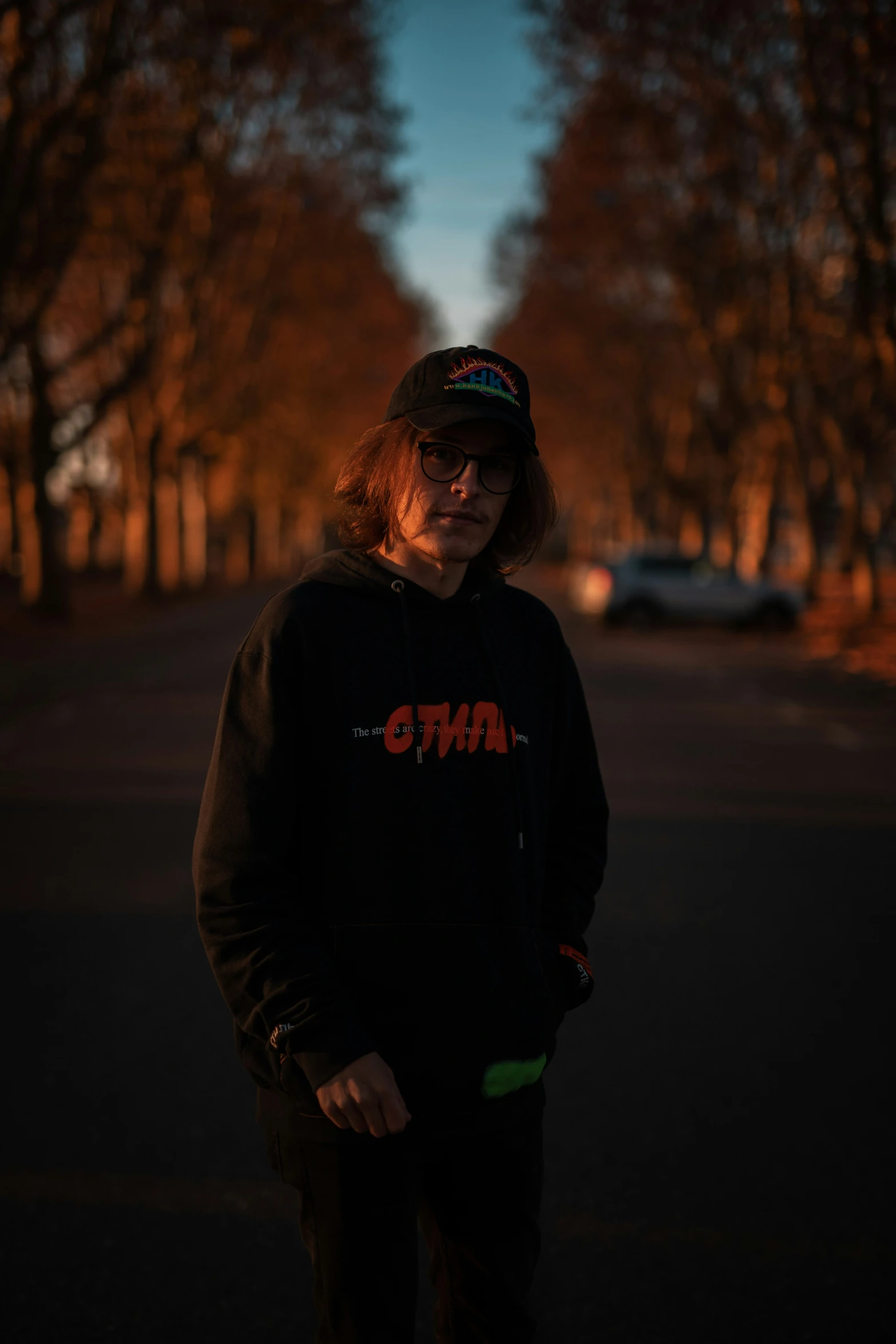 a man is standing on a skateboard in the middle of the street