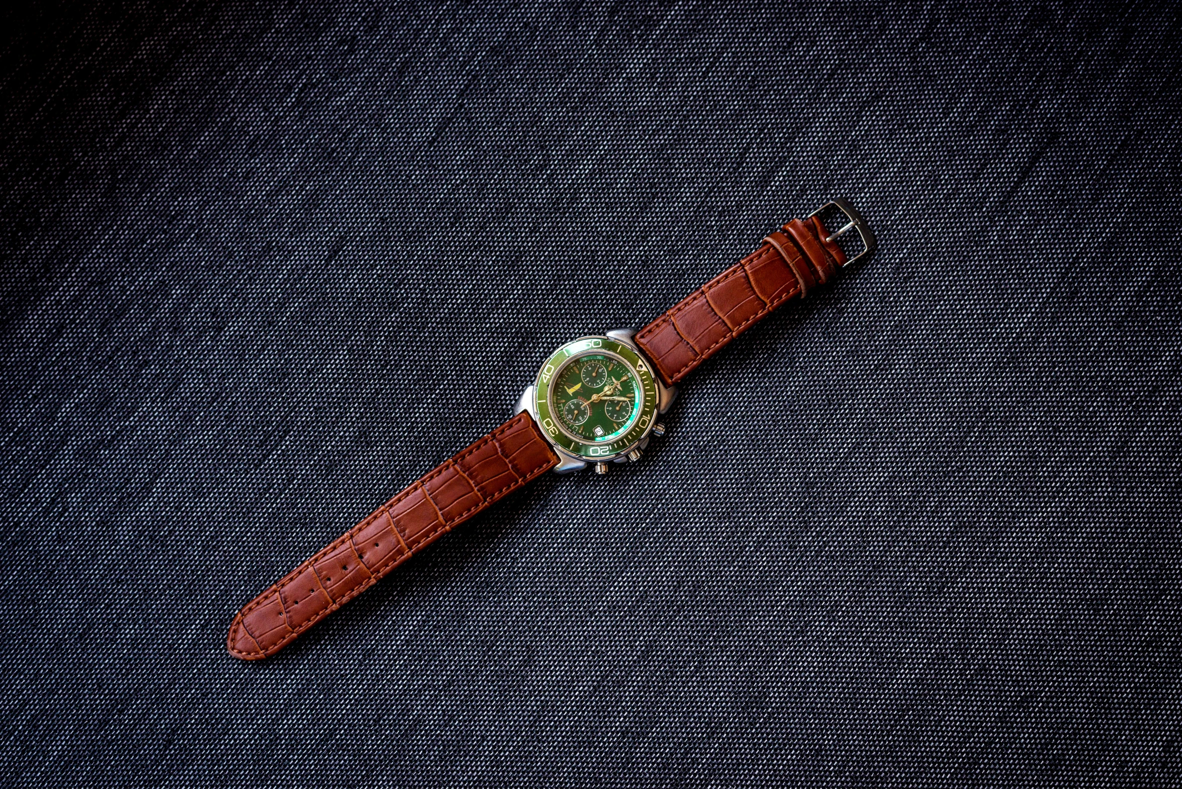 a watch is sitting on top of a blue cloth