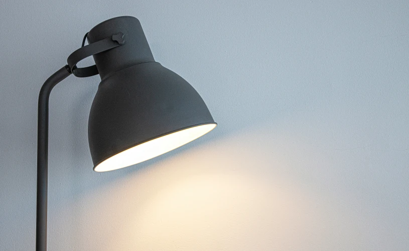 an angle lamp sitting on top of a wall