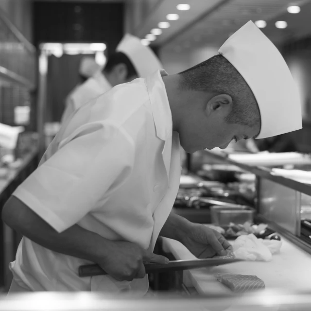 two chefs work in a restaurant kitchen