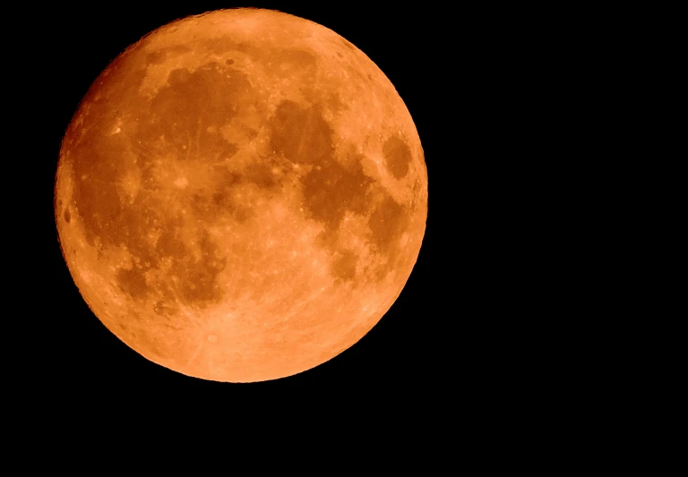 the full red moon is on its own side, but in the dark sky