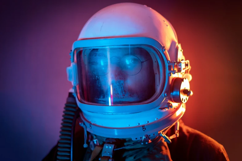 an old spaceman's helmet is in a purple room