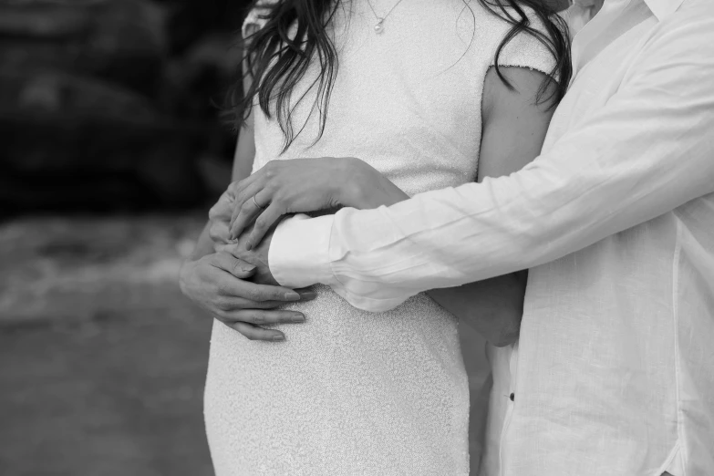 black and white picture of a man hugging his wife