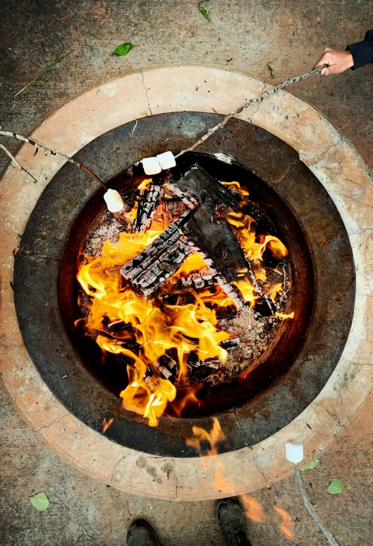 an open fire pit with lots of burning flames on top