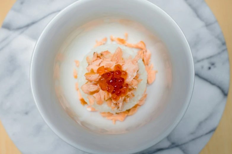 a bowl containing dessert like desert and toppings on a table