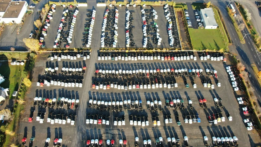 an aerial view of parking lot in front of buildings