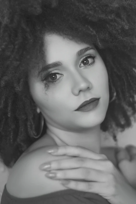 a black and white image of a woman with natural makeup