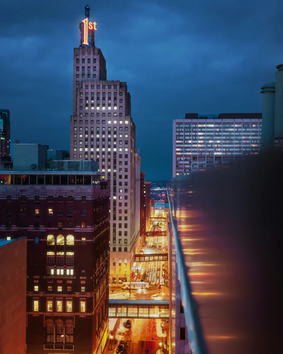 the view of city lights and buildings from an overpass