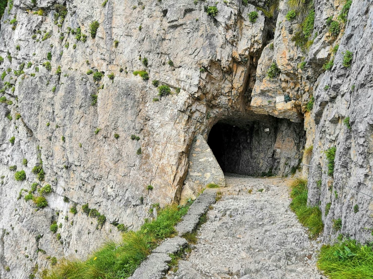 there is an entrance to a cave in the side of a mountain