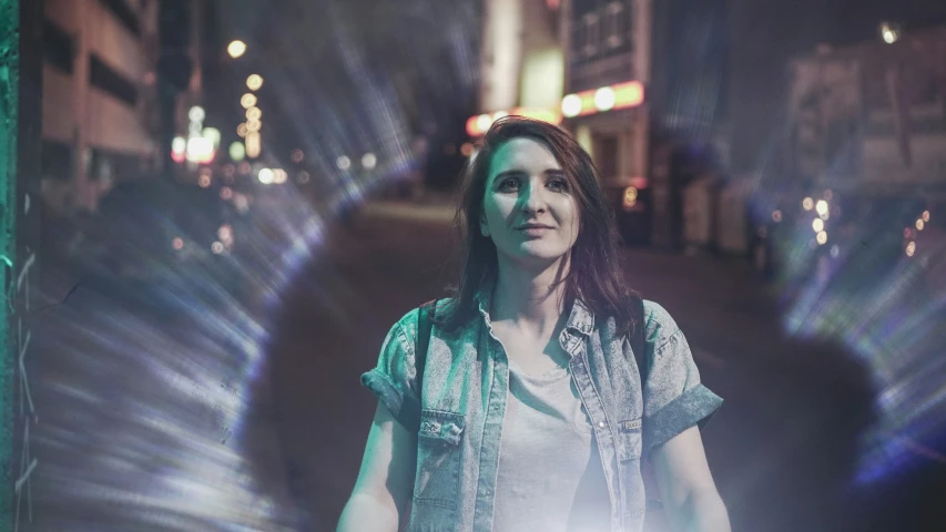 a woman stands next to a wall in the dark