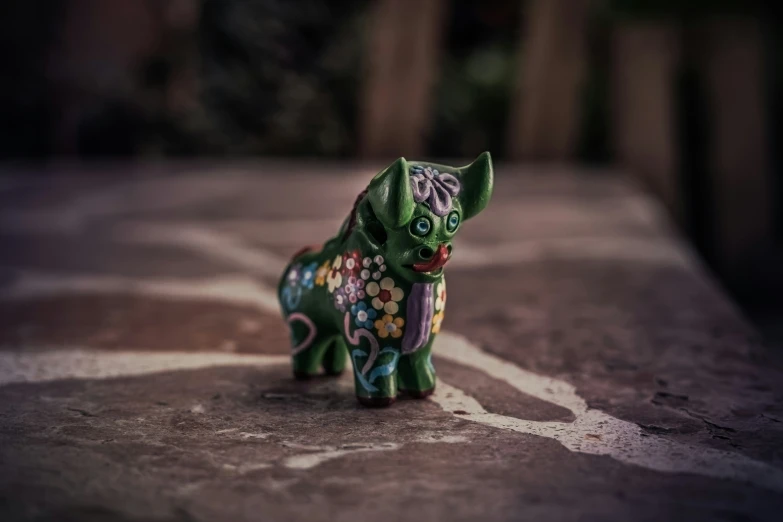 a toy figurine on a table near a fence