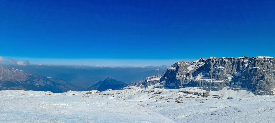 a person is standing on a snow covered hill