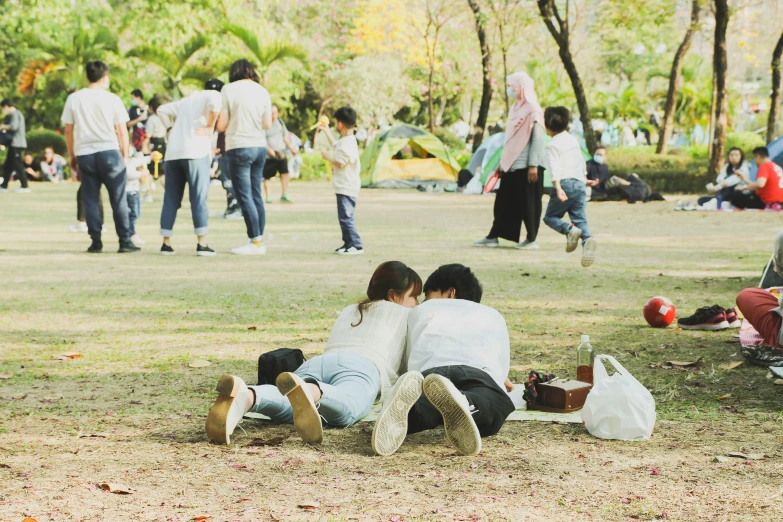 people in the park, some sitting on grass