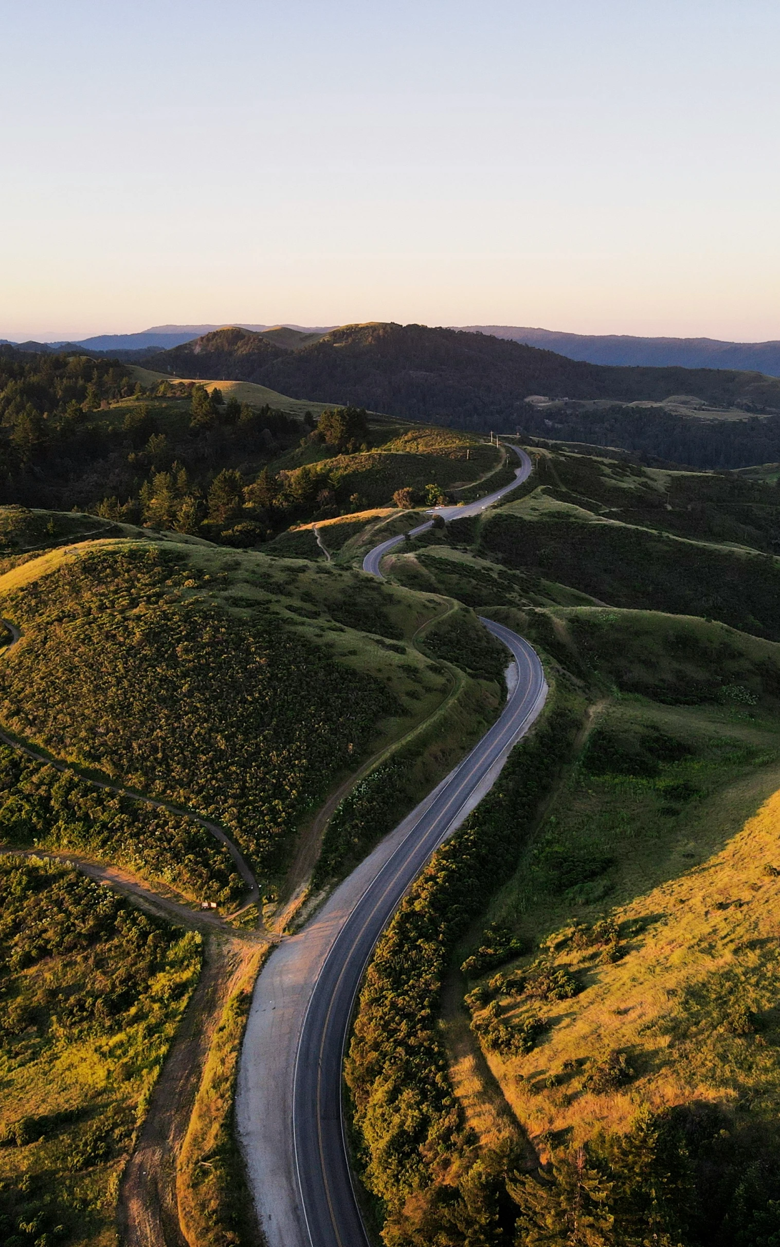 an empty curved road in the middle of nowhere