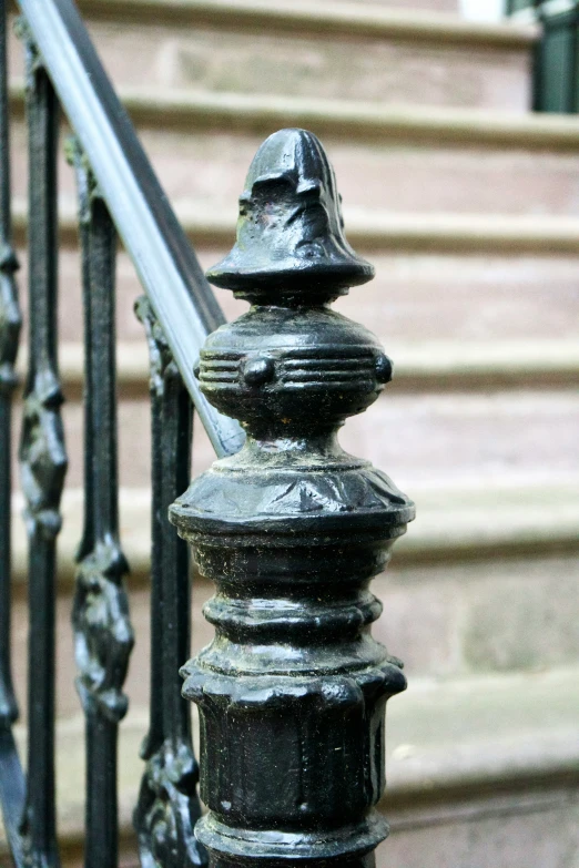an iron railing and railing baluster outside the stairs