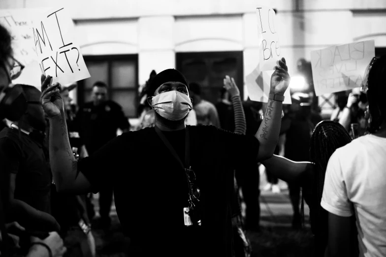 protesters in a line outside holding up signs