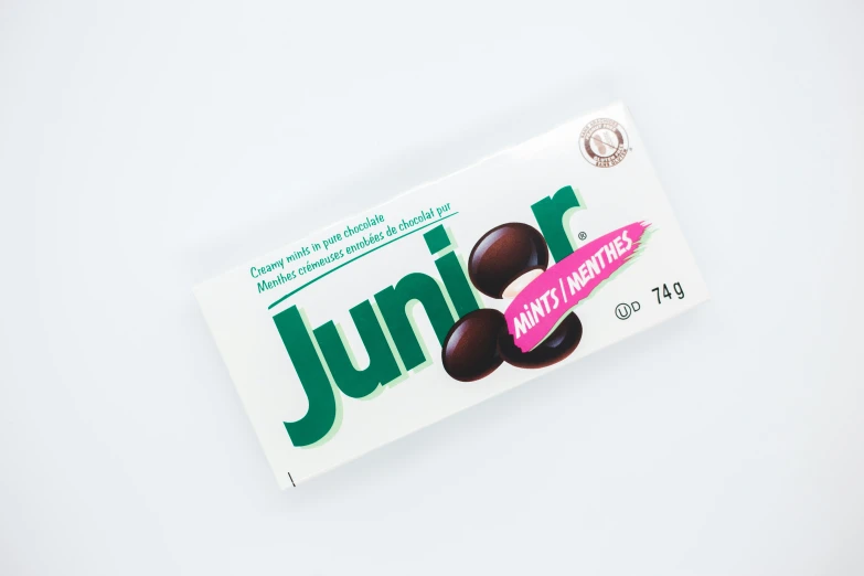 a white box of junk with chocolate covered in pink icing