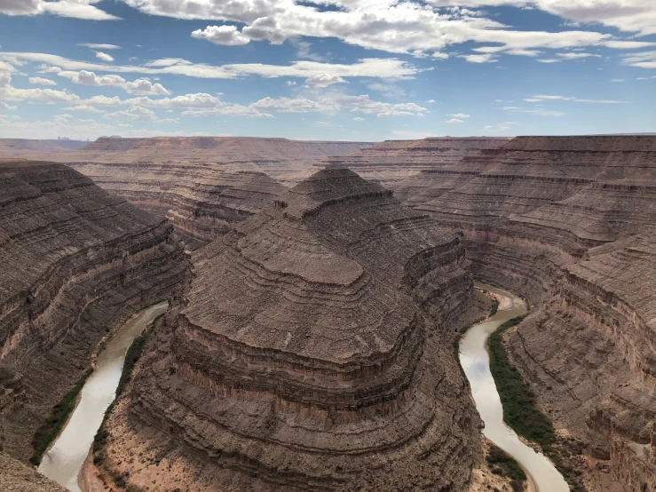 a river cuts through the canyon into its surroundings