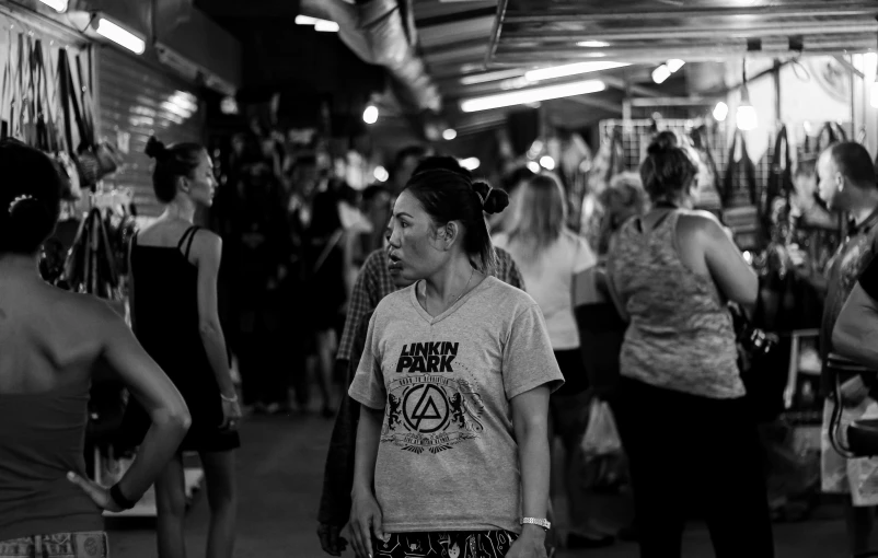 a group of women walking through a wet market