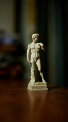 a  male figurine on a wooden surface