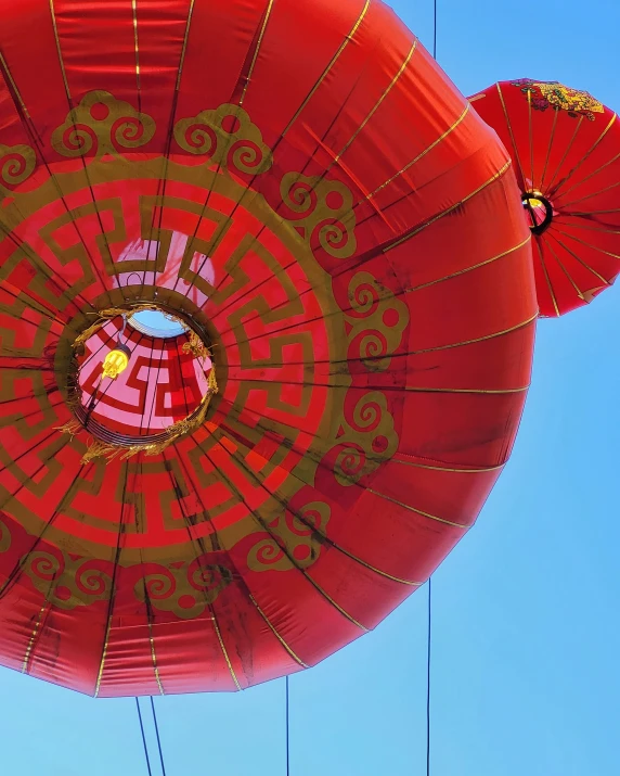 two red balloons with symbols in the middle