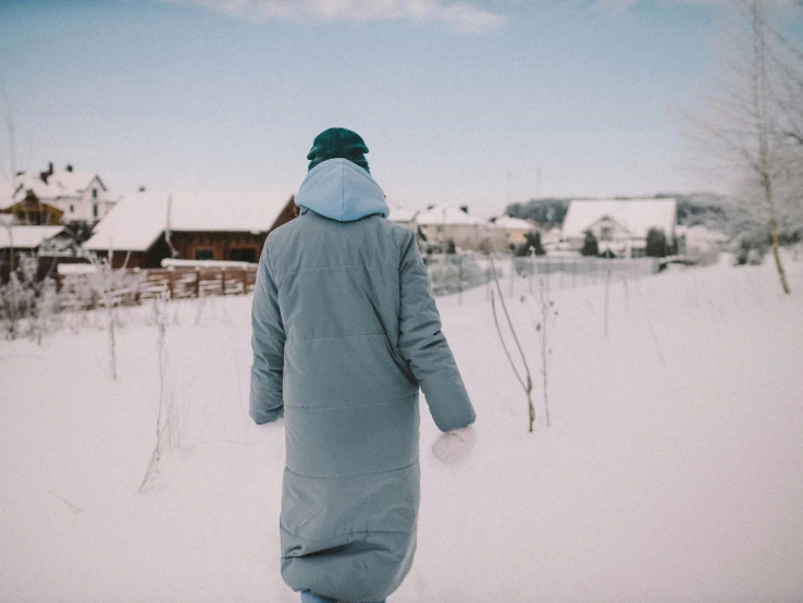 a person that is wearing a coat in the snow