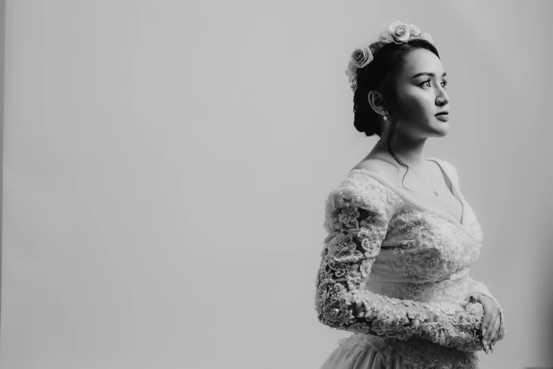 a woman wearing a long white dress poses for a po