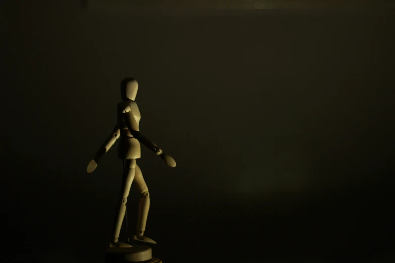 a wooden dummy standing on top of a table