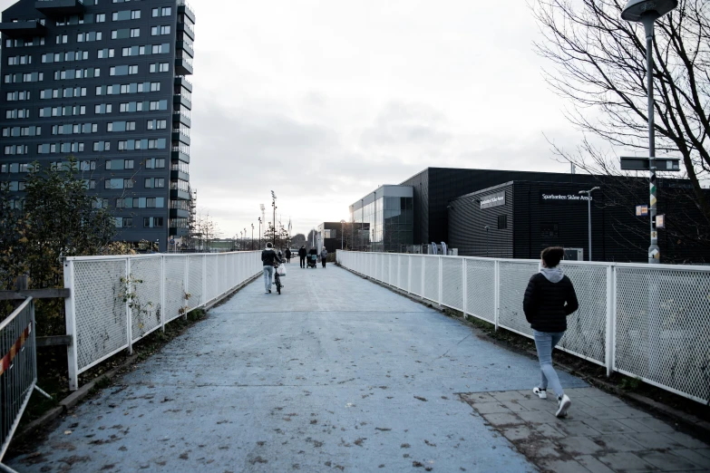 a couple of people walking down a walkway