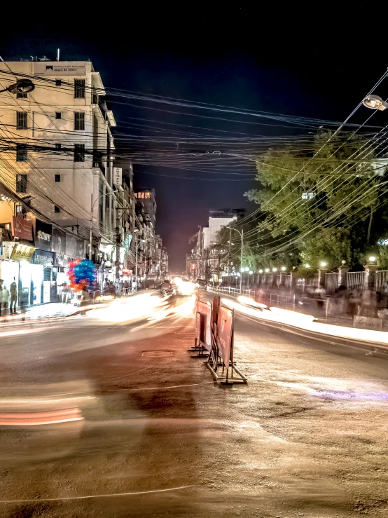 a street scene with cars driving in the light