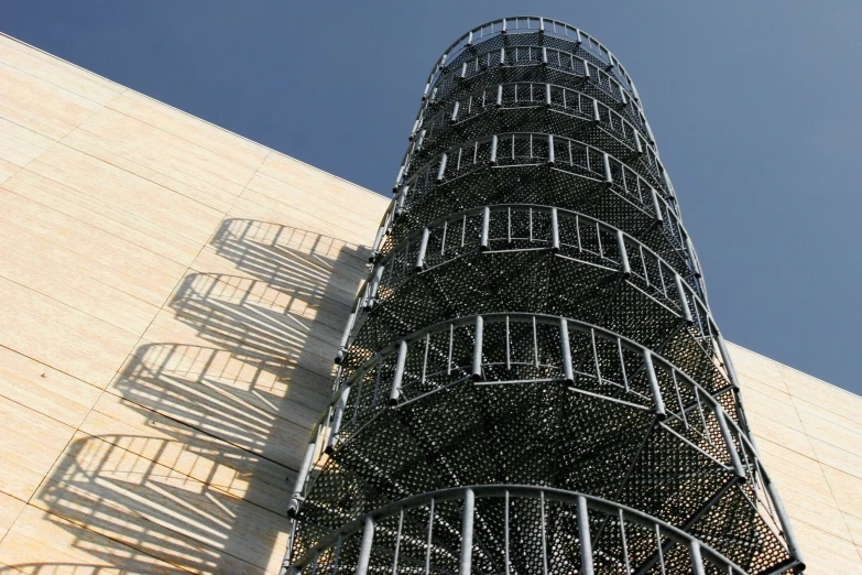 this is a metal spiral staircase that leads up to the top of a wall