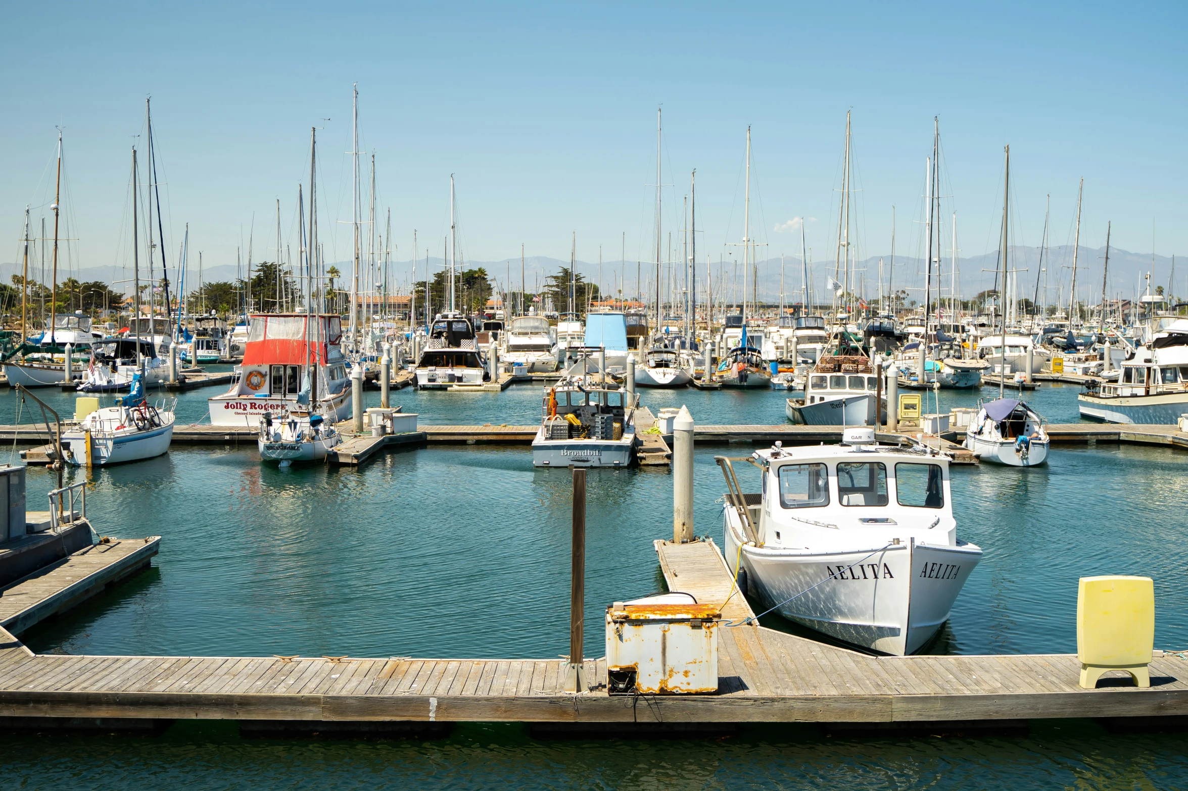 a dock with several docked boats at it