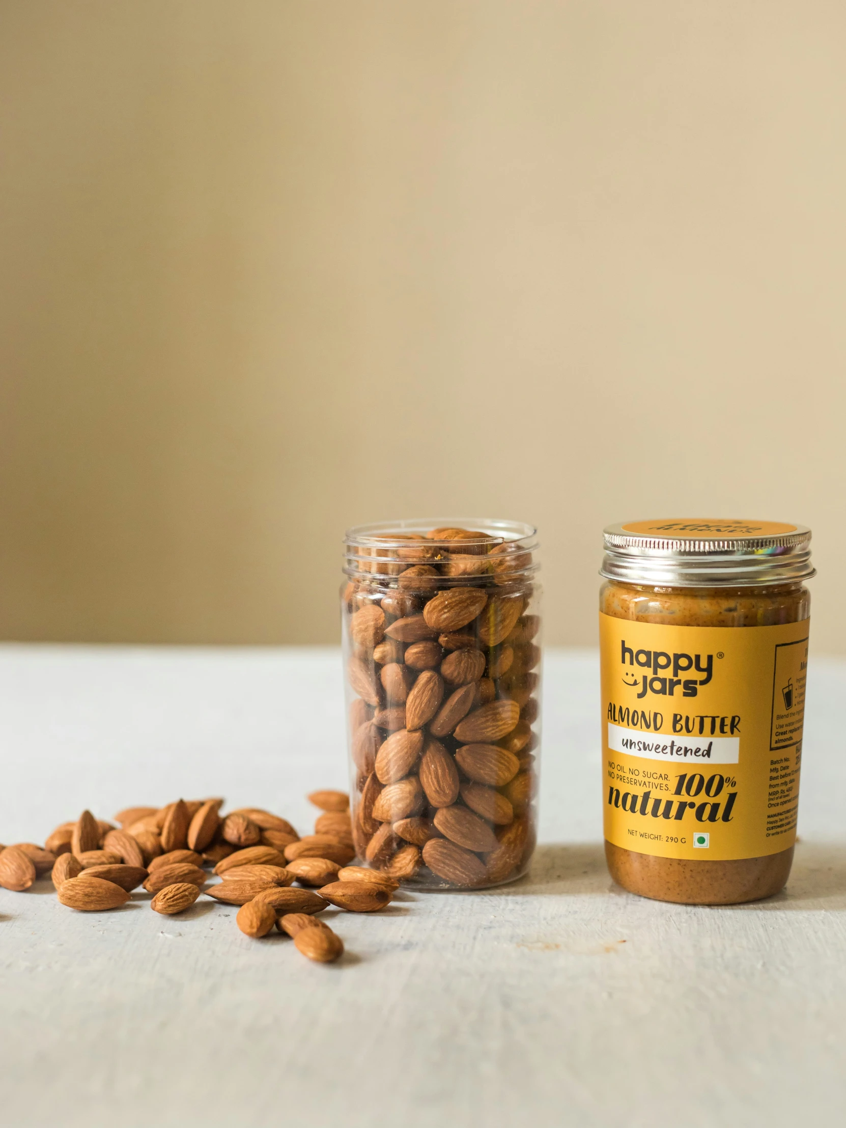 almonds and peanuts sit in small glass jars