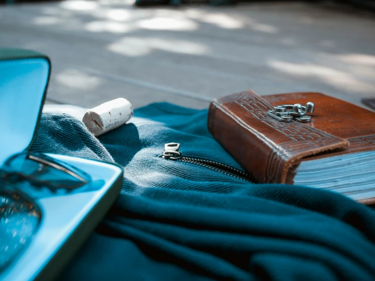 a notebook on a blanket next to a white bottle