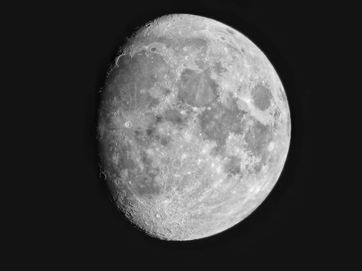 a full moon is shown in black and white