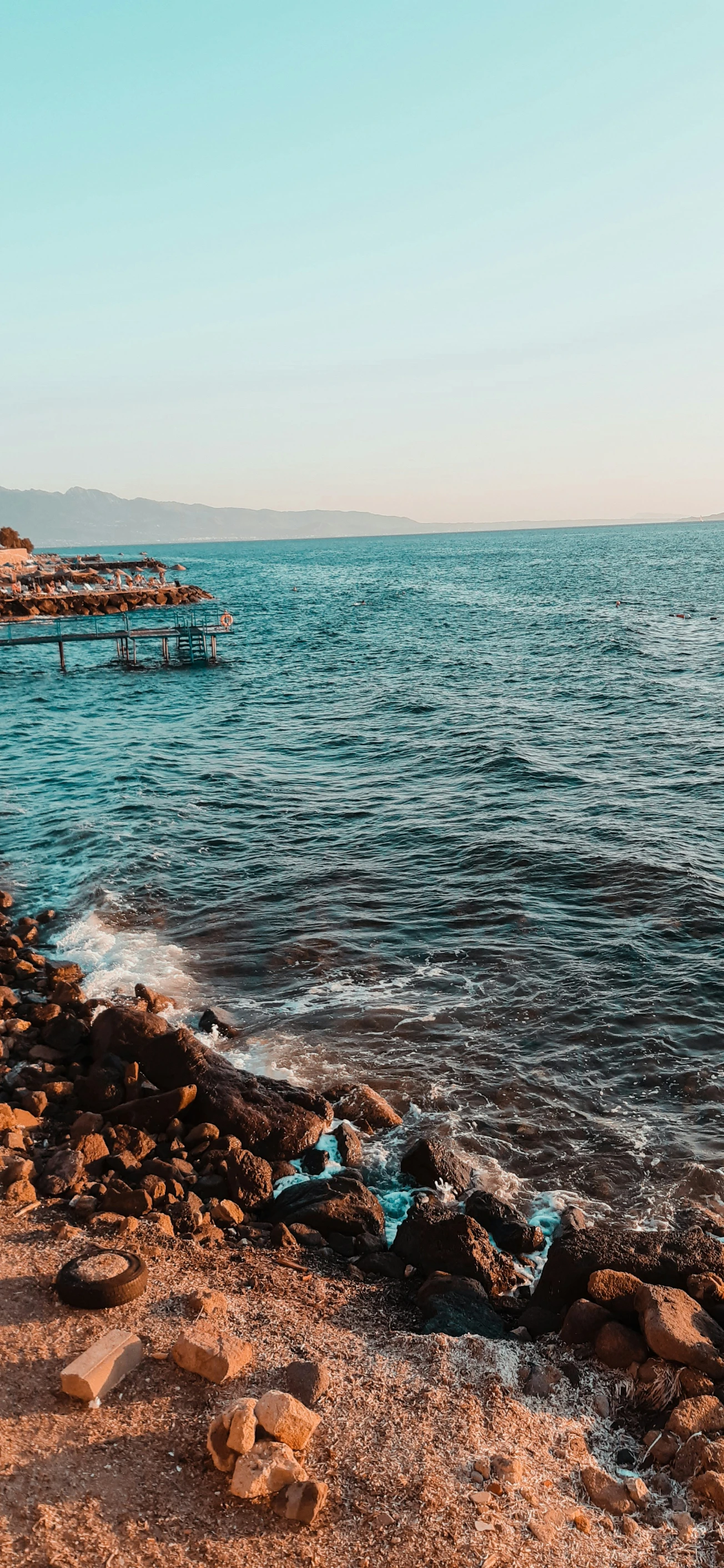 the beach has small waves on the water