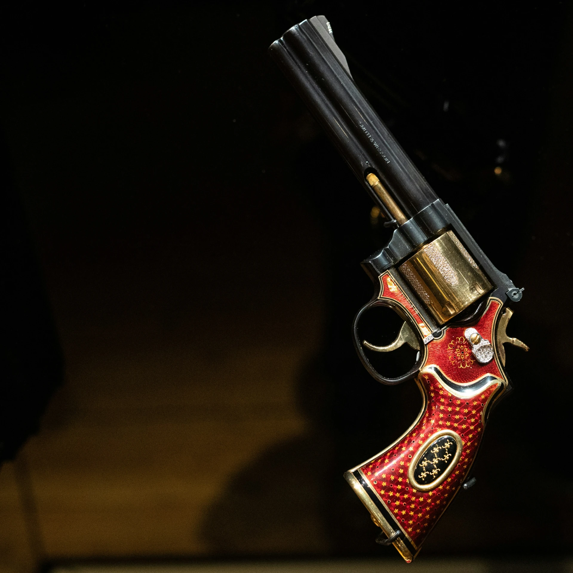 a gun with red paint on it with a black muzzle