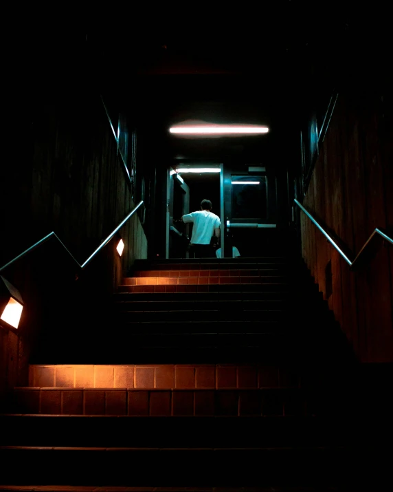a person walking down some stairs with some lights on
